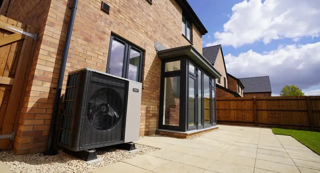 Ideal Heating air source heat pump installed at the side of a home in Newton Abbot.