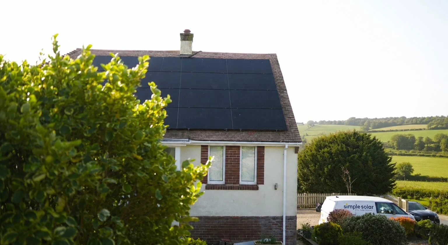 Simple Solar van parked outside a home with newly installed solar panels in the West Devon countryside