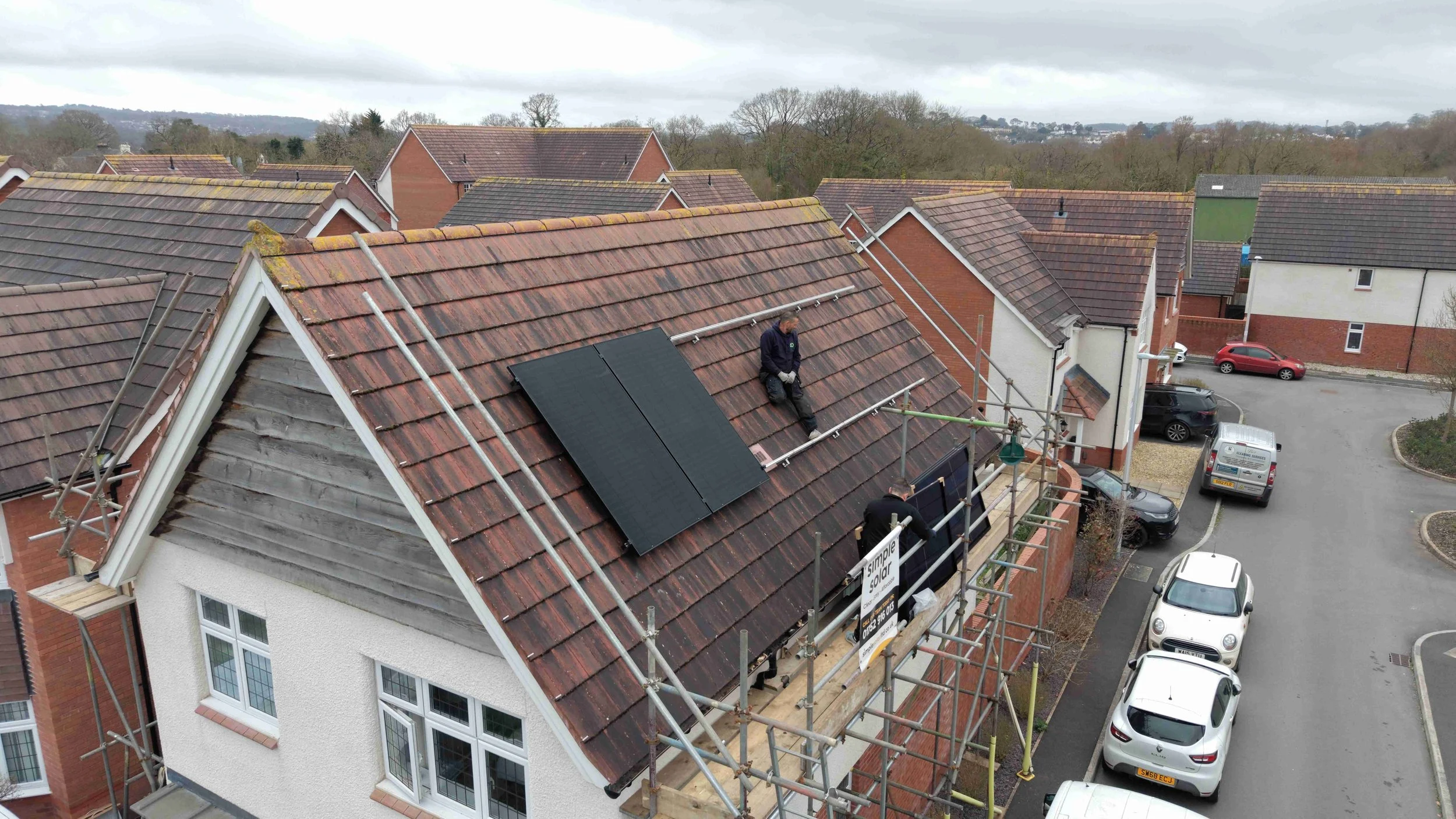 Solar installers fitting panels on a South West UK home