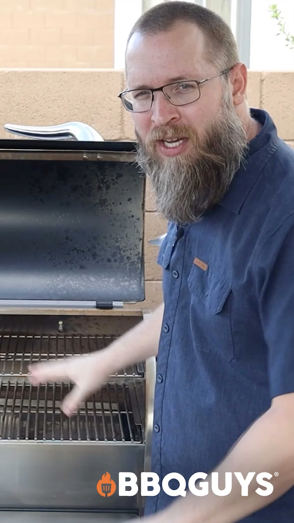 BBQGuys expert demonstrating a Recteq 1250 pellet grill in a vertical product review video