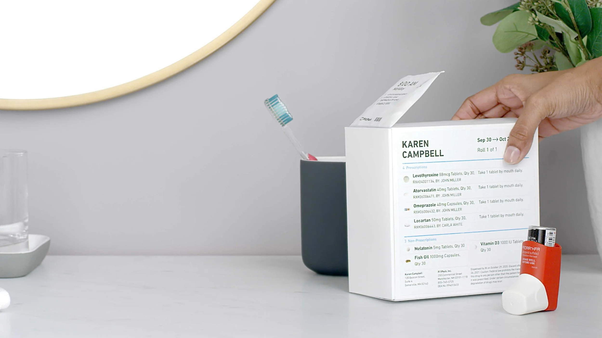 A woman places a PillPack dispenser on a bathroom counter