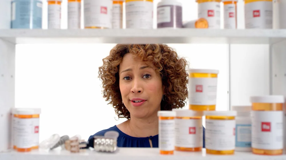 PillPack TV Commercial woman stands behind medicine cabinet full of pill bottles