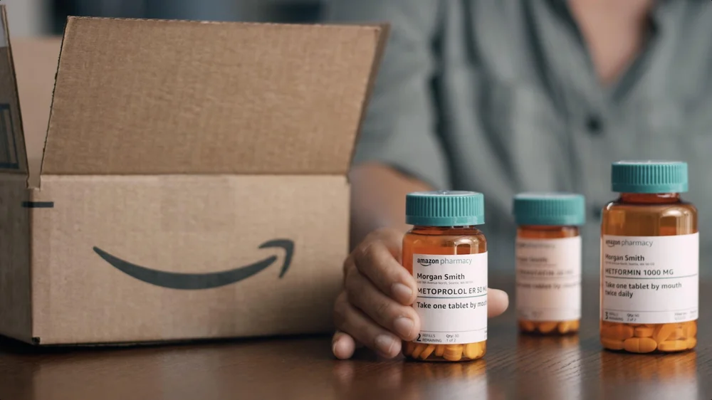 Amazon Pharmacy Launch Video and Commercials woman sets pill bottle on counter in front of Amazon box