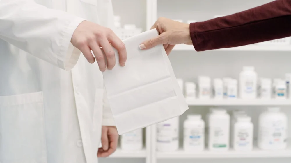 PillPack TV Commercial Video pharmacist hands customer a bag at pharmacy