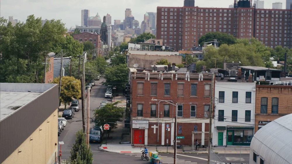 Brooklyn, NY, an e-bike rider delivers Amazon packages in a documentary video