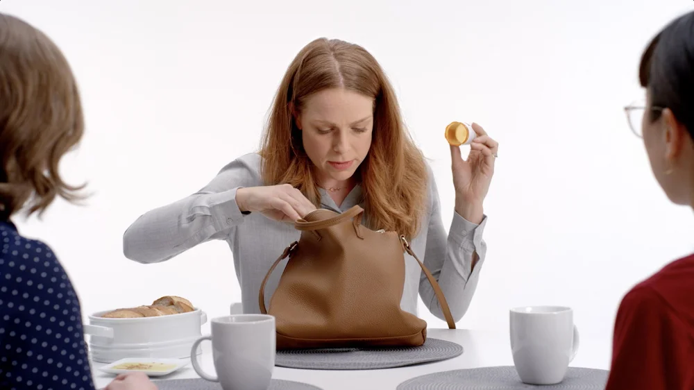 PillPack Broadcast TV Spot woman looks through her purse for medication at lunch