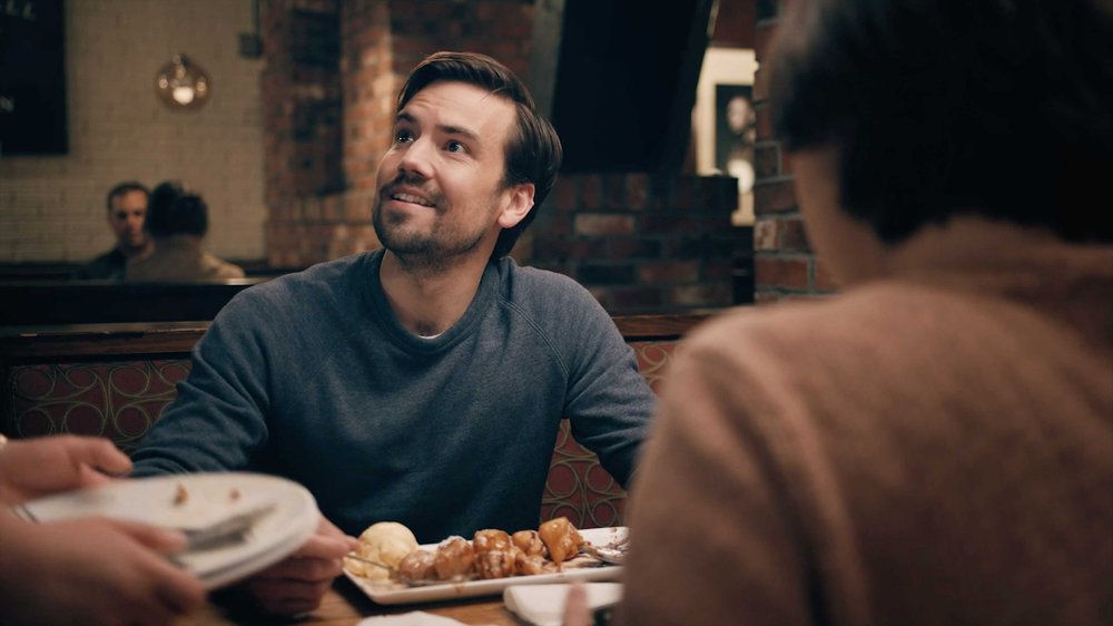 Man smiling at server while dining inside Uno Pizzeria & Grill restaurant in comedy commercial