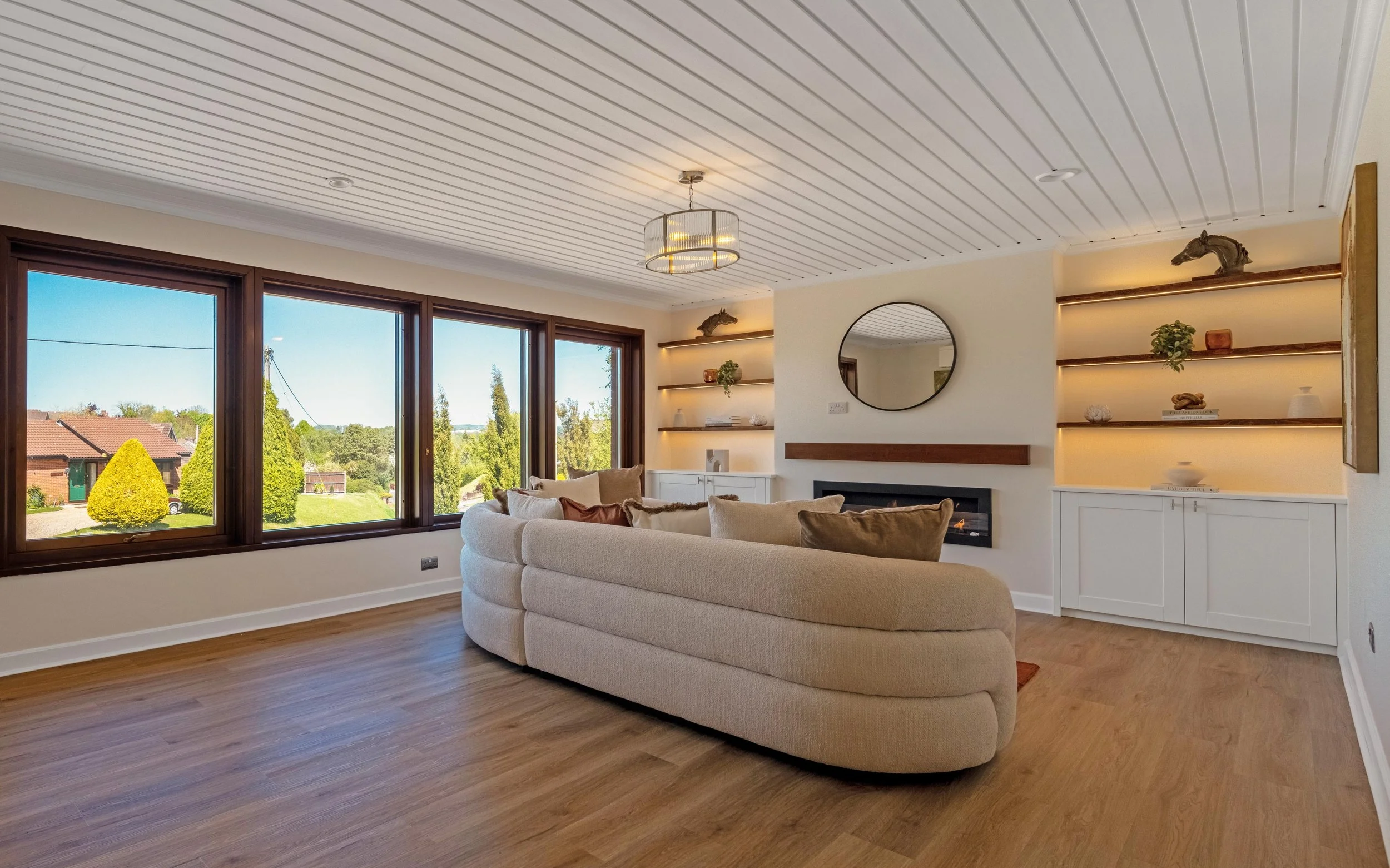Living room after refurbishment with media wall and feature fireplace - The Chic Relic UK