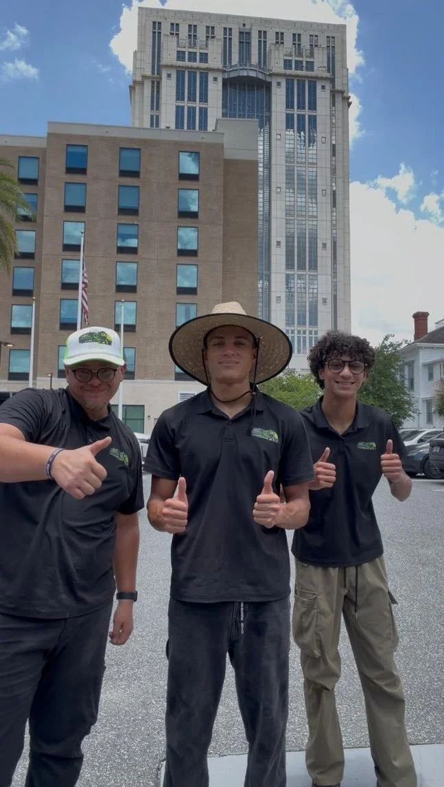 The Amigos Junk Removal crew giving a thumbs up