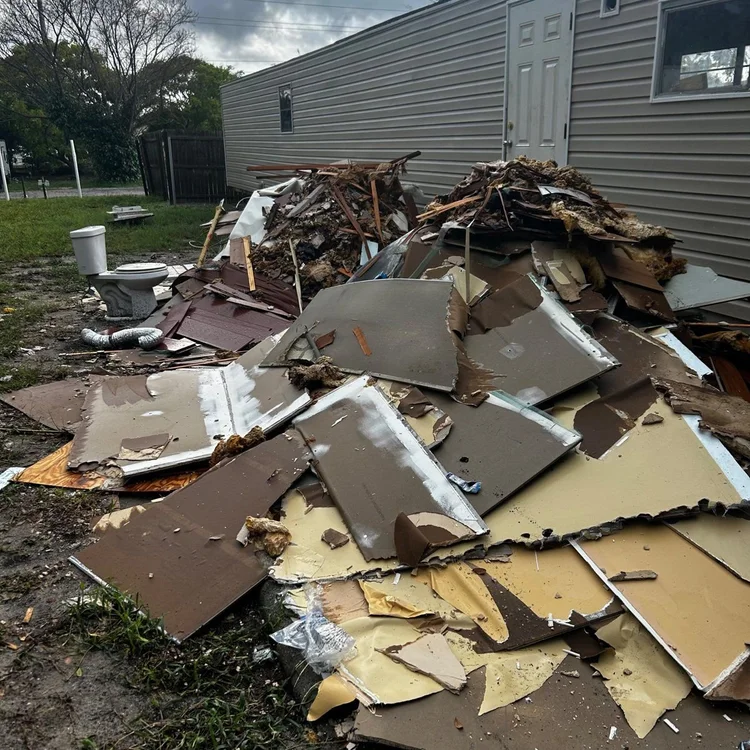 Demolition debris next to a mobile home