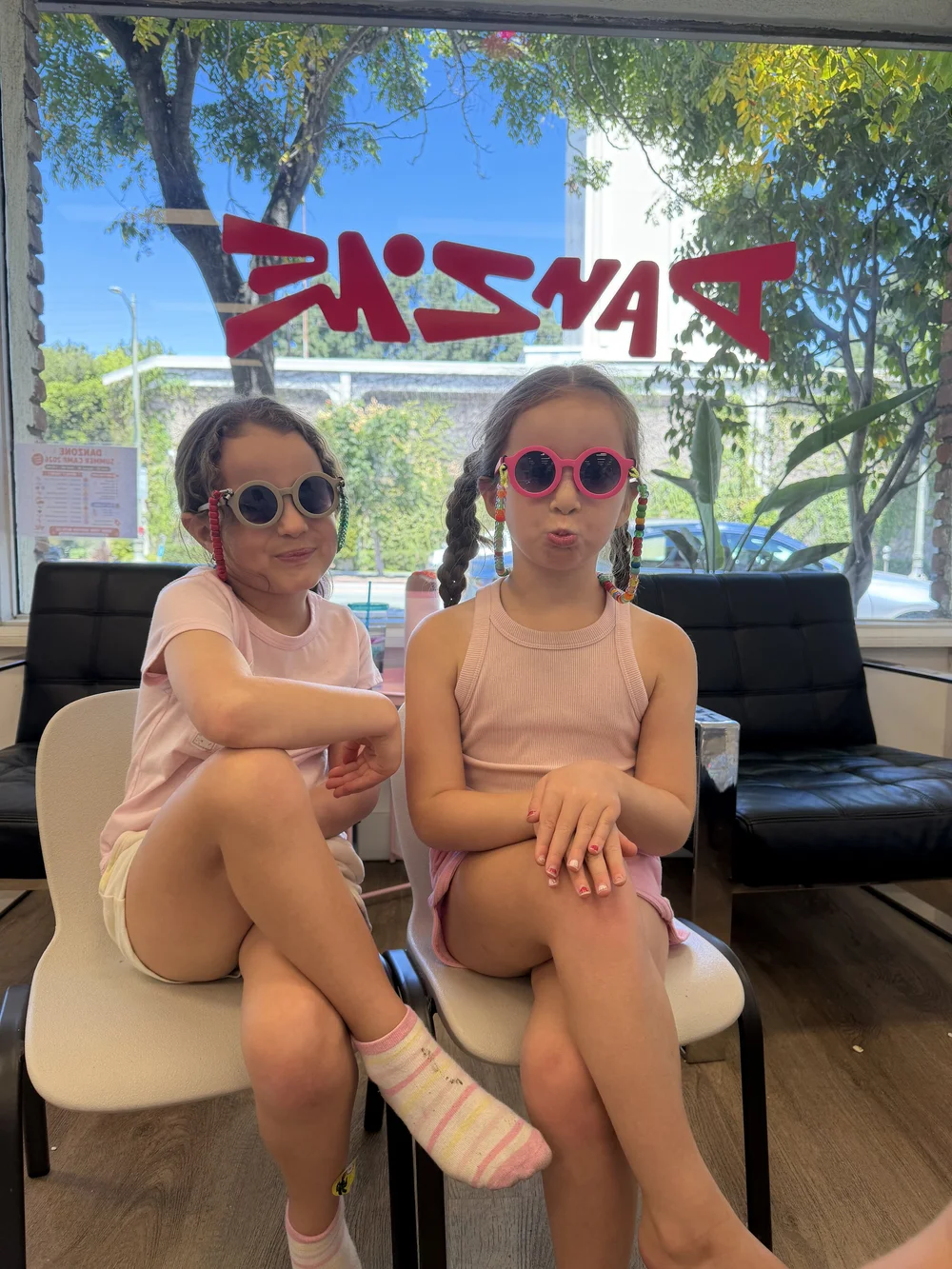 Two campers posing in their decorated sunglasses
