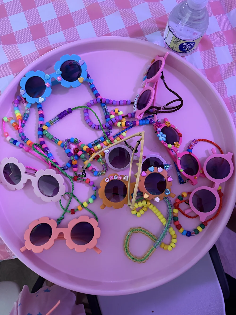 Tray of sunglasses and beaded straps campers decorated