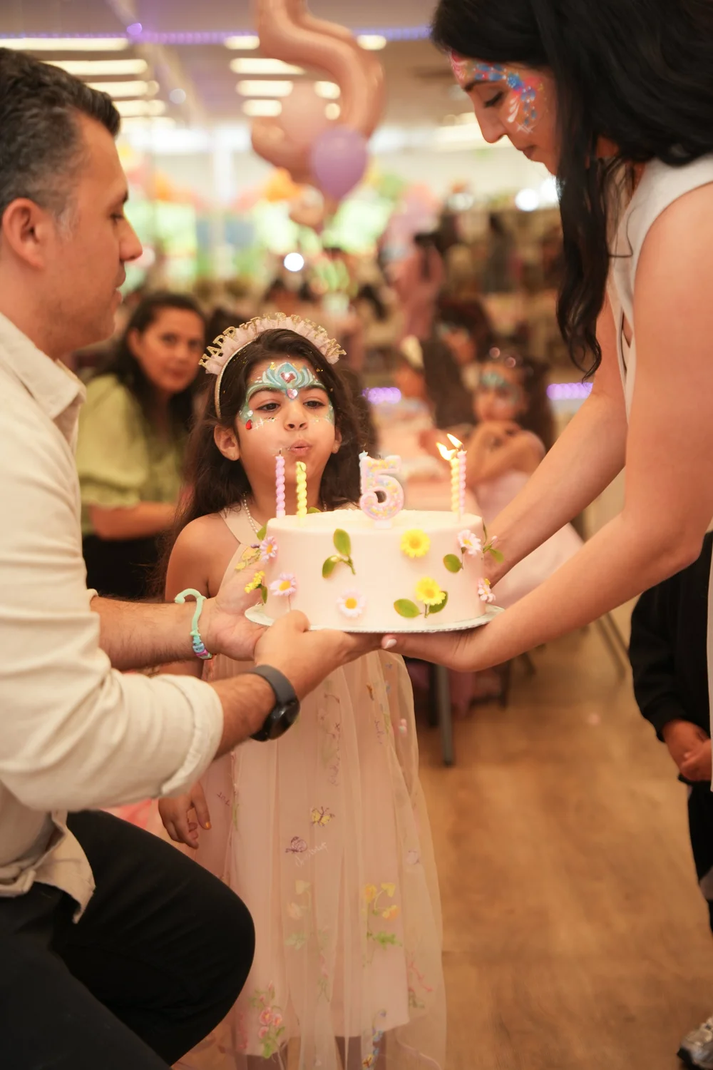 Birthday girl blowing out the candles on her cake