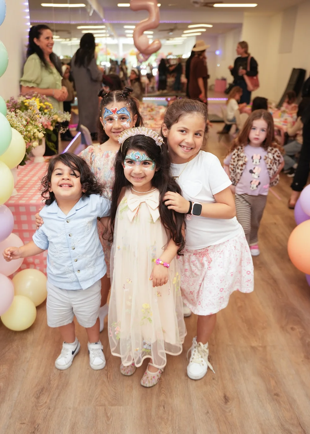 Party guests with face paint smiling together