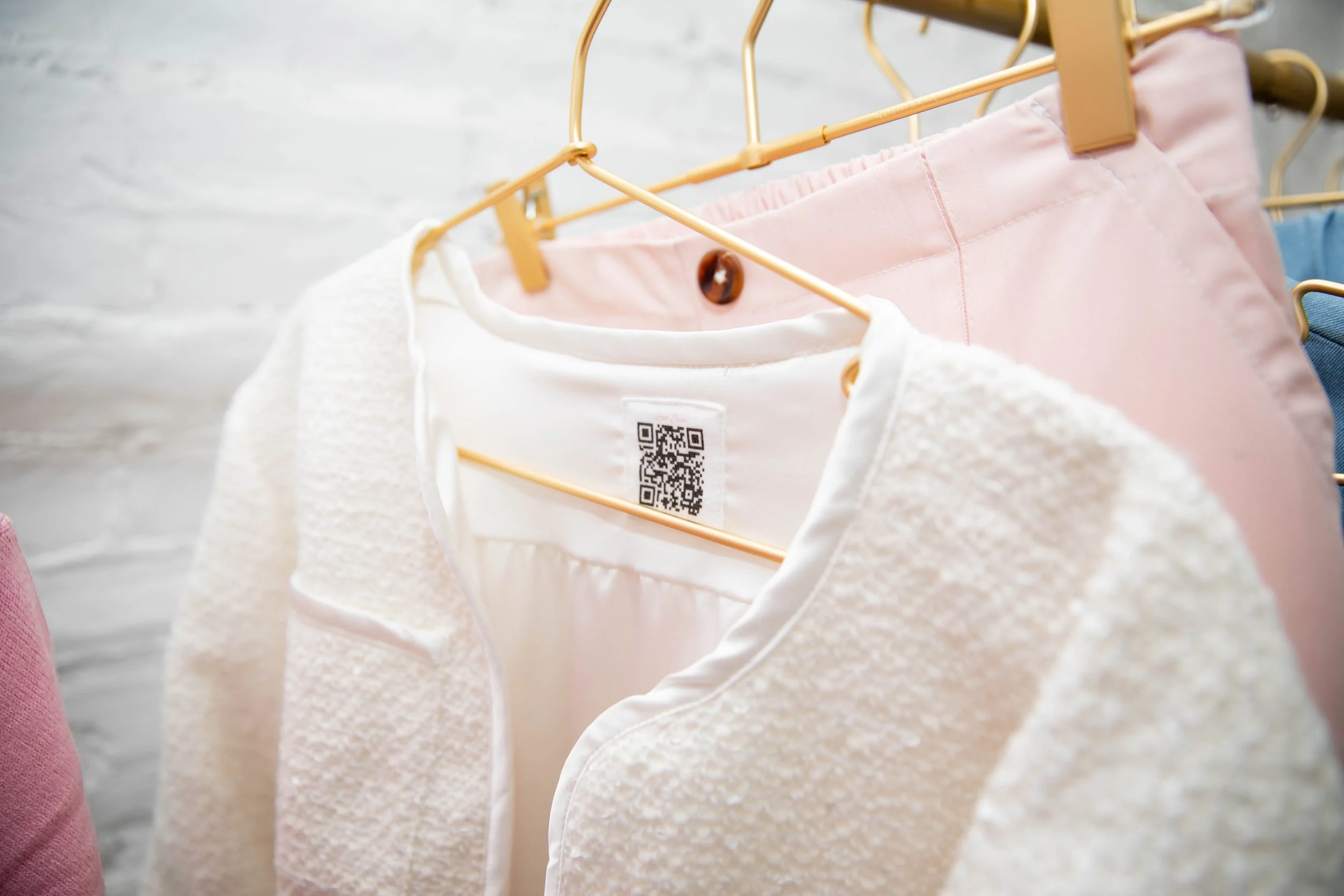 Close-up of the sewn-in QR code label inside a Love, Emma garment