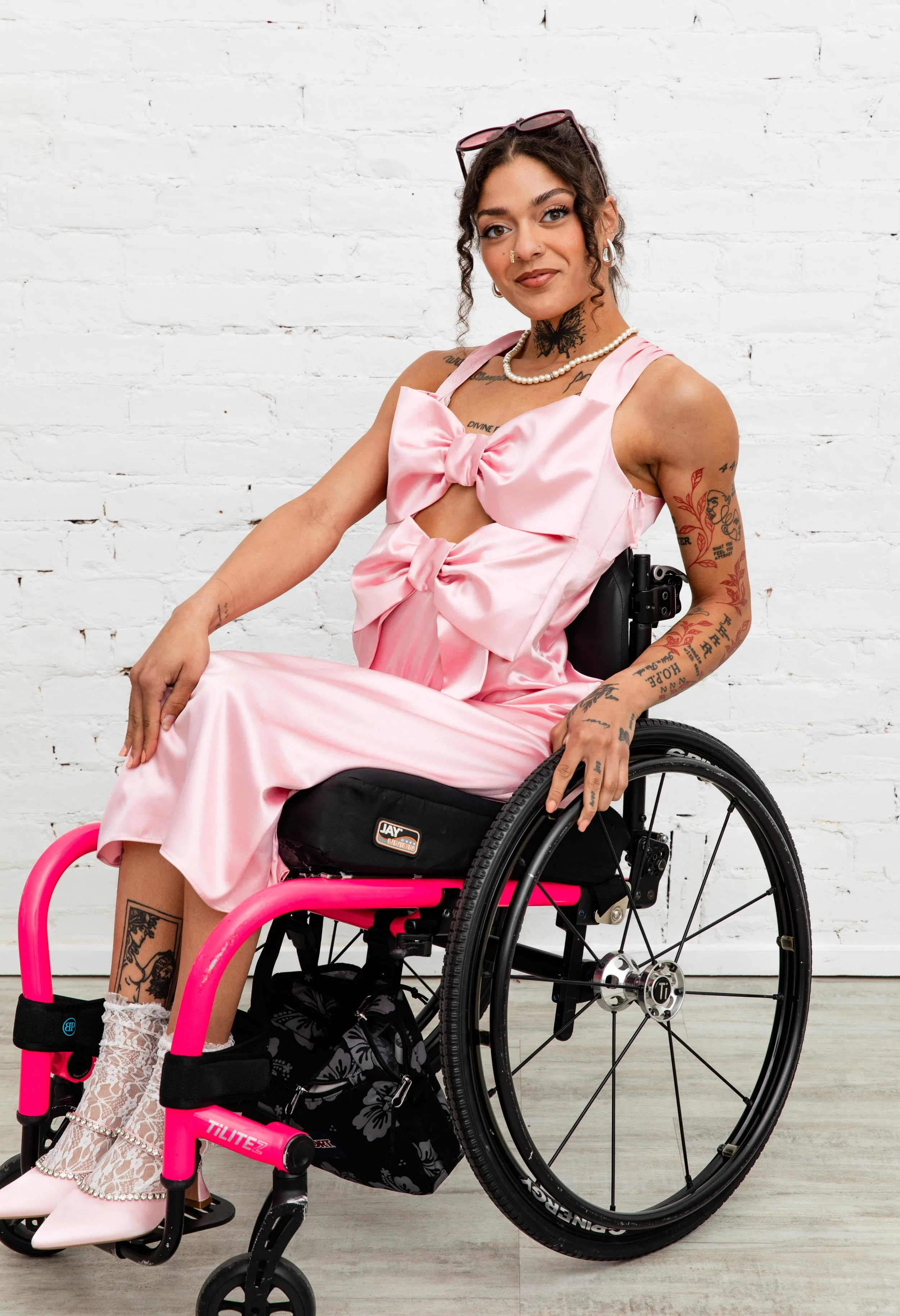 Model wearing a Love, Emma top with a full-length side zipper and fabric loop zipper pull showing access from waist to neckline