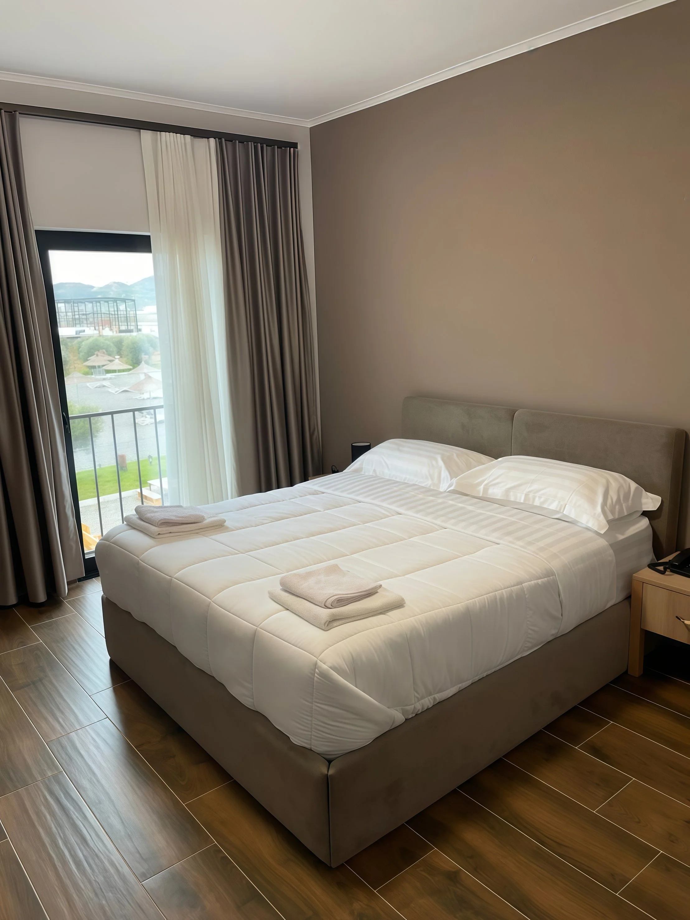 Bright room with large bed and balcony view