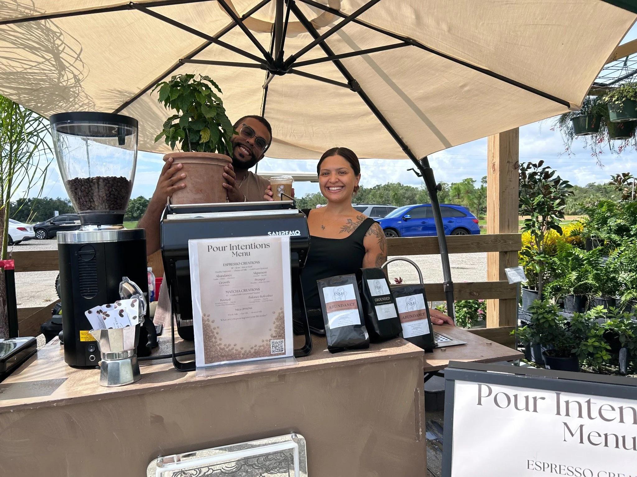 Stephaney and Devin serving coffee at the Pour Intentions cart