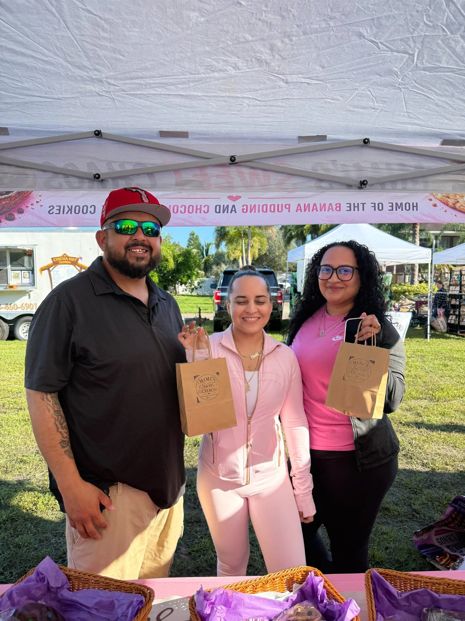 Local vendors smiling at their market booth