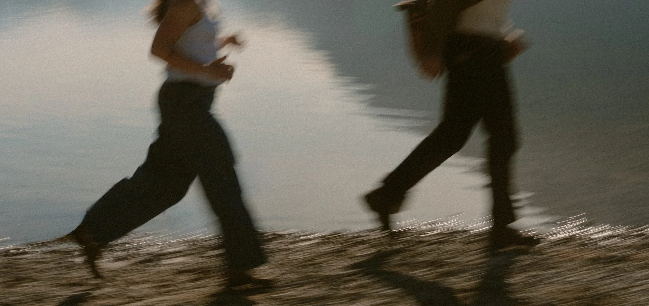 Motion-blurred photograph of a couple running beside the water at Golden Ears
