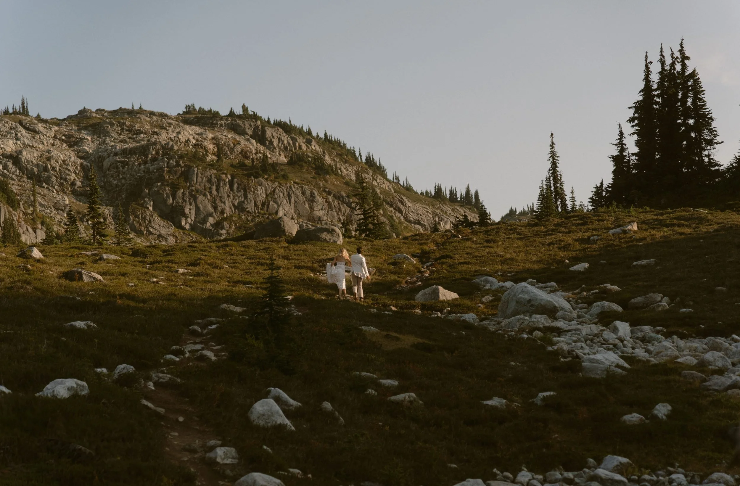 A couple walking through rocky alpine terrain at Semaphore Lakes near Pemberton