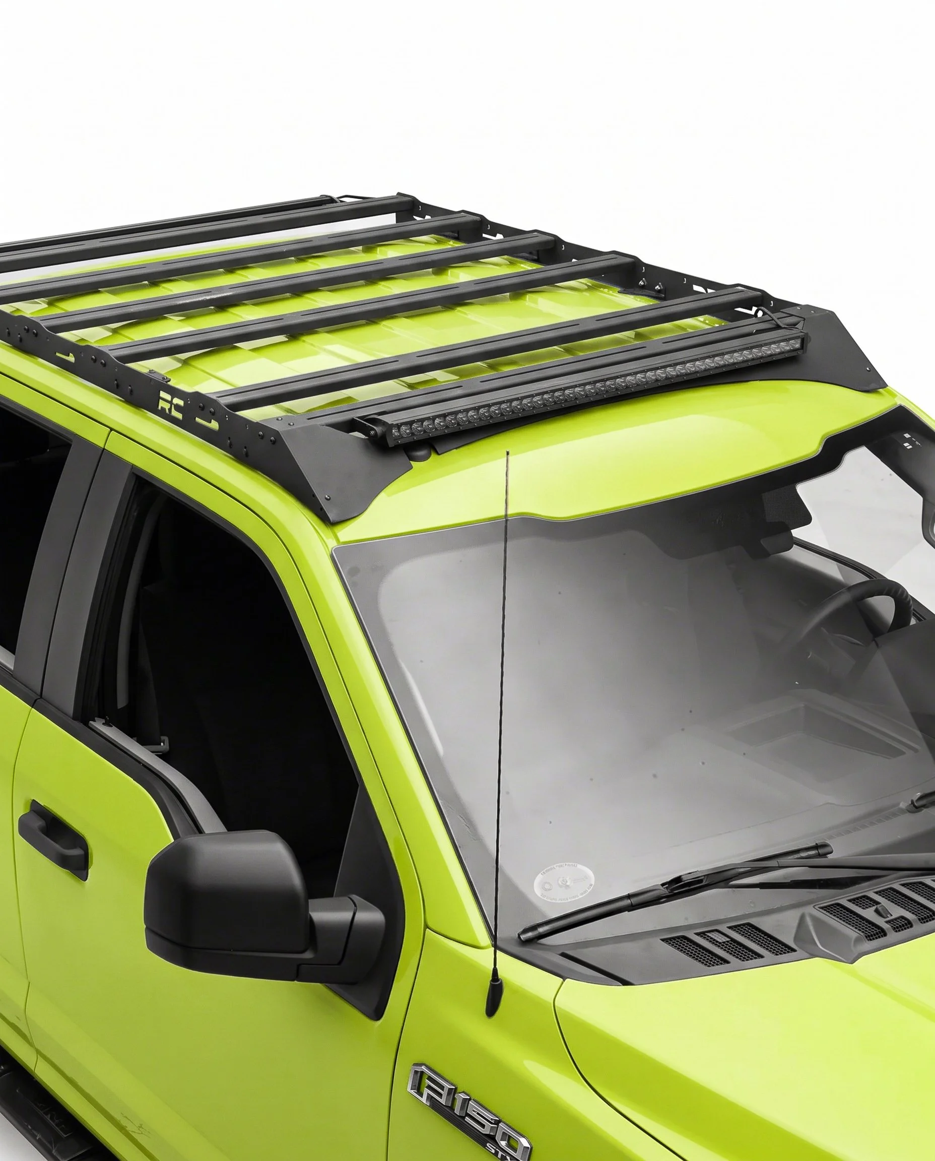 Full-length platform roof rack with an integrated LED light bar mounted across the cab roof of a Ford F-150.