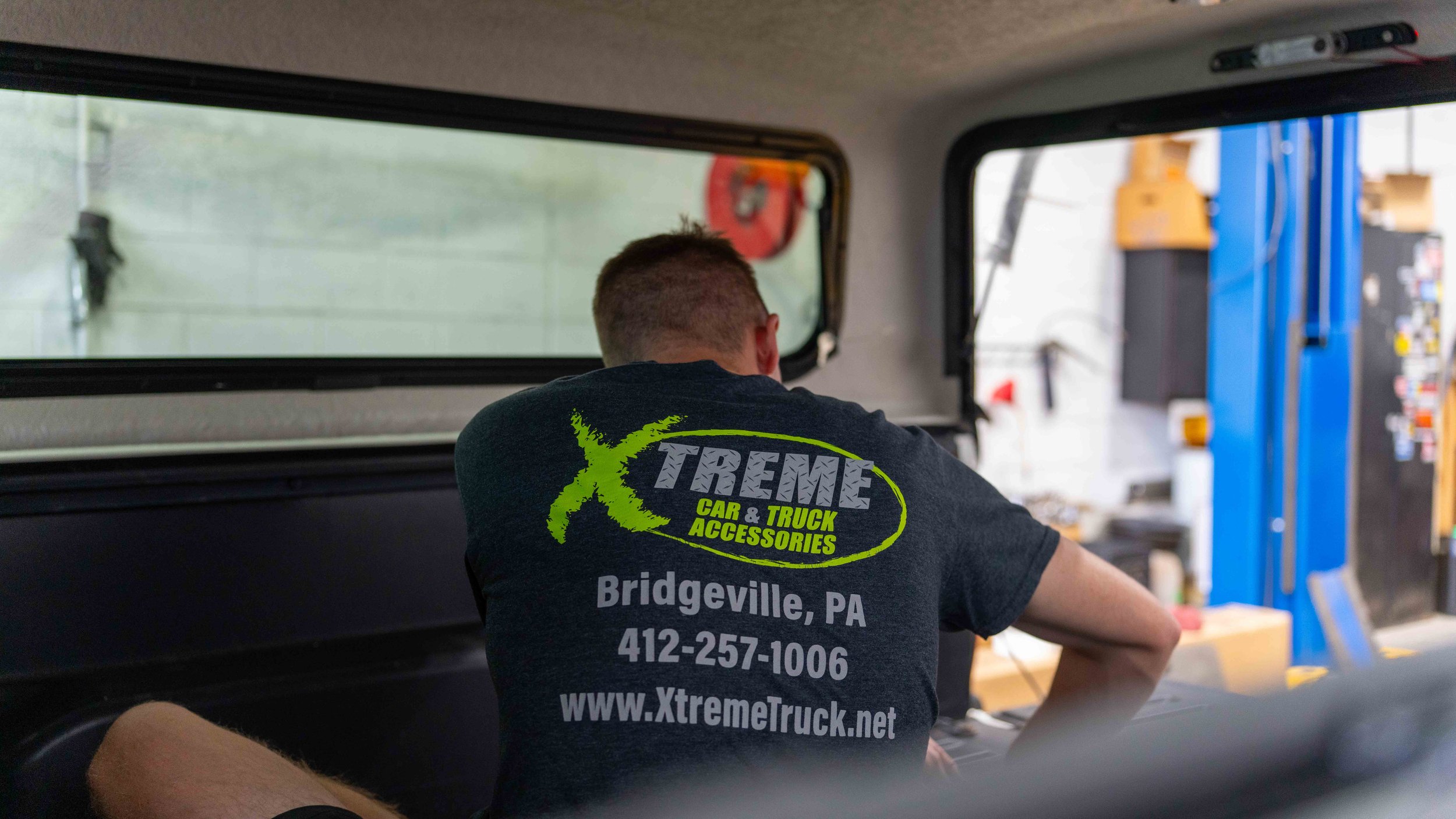 Xtreme Car and Truck Accessories installer working inside a truck cap during a cap installation in Bridgeville, PA