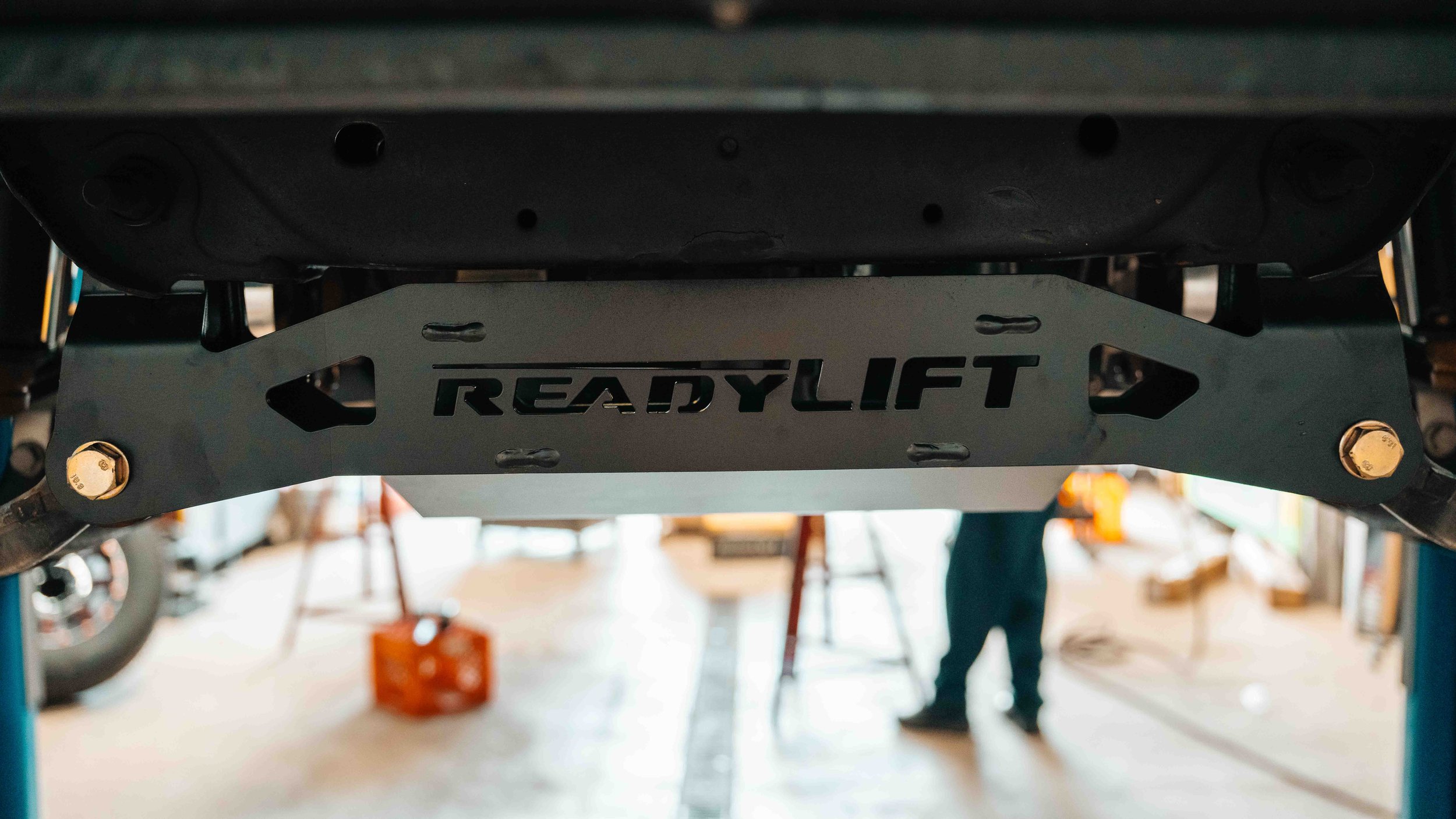 ReadyLIFT front crossmember installed under a GMC Sierra as part of a 6-inch MAX3 suspension lift kit.