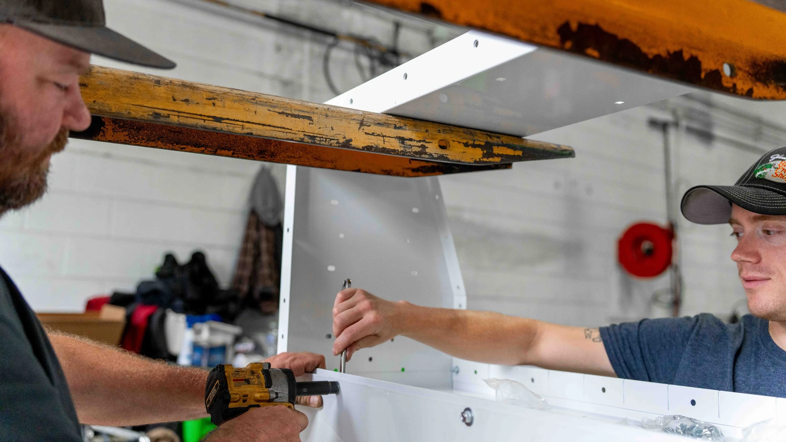 The Xtreme Car & Truck Accessories team installing commercial van shelving at their shop in Bridgeville, PA
