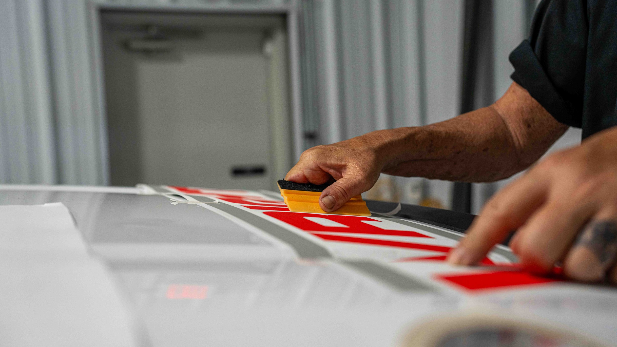 Xtreme Car and Truck Accessories installing custom vinyl lettering on a commercial work truck for fleet branding and business vehicle graphics in Bridgeville PA