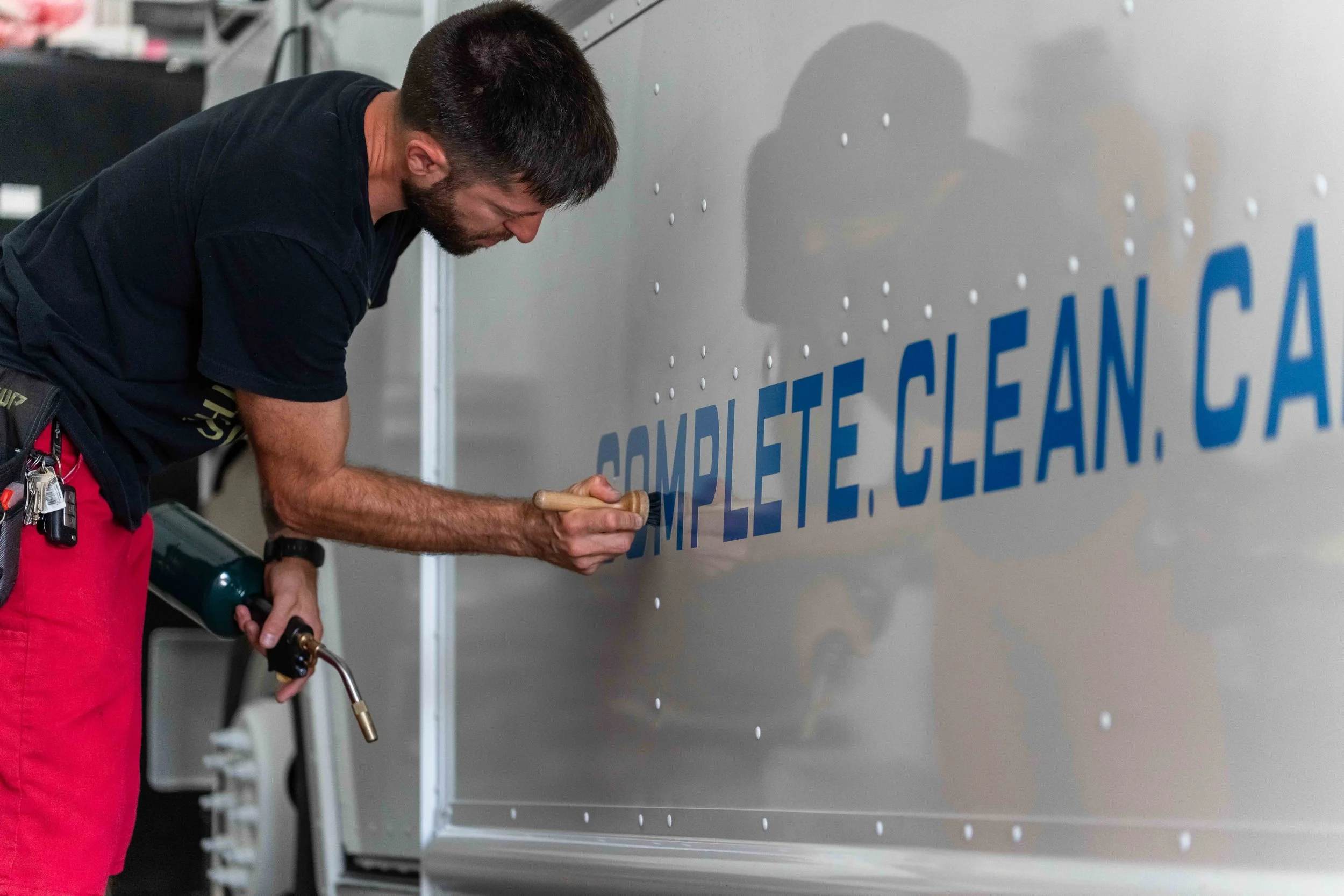 Model Uniforms rental delivery van featuring custom vinyl graphics designed to turn a commercial service vehicle into clean, professional mobile advertising.