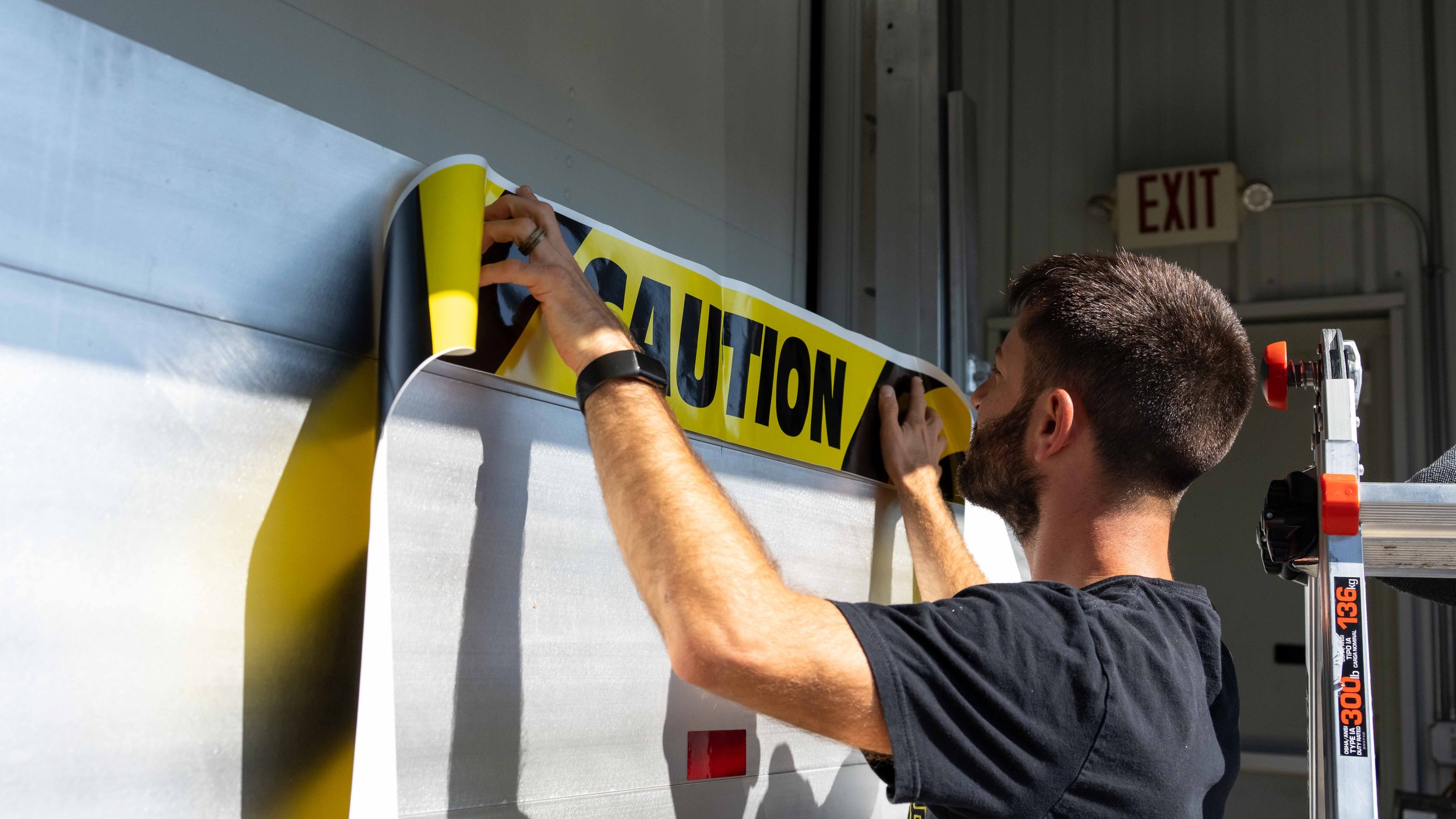 Model Uniforms rental delivery van with precision-installed vinyl graphics and fleet branding created for clear, professional business identification on the road.
