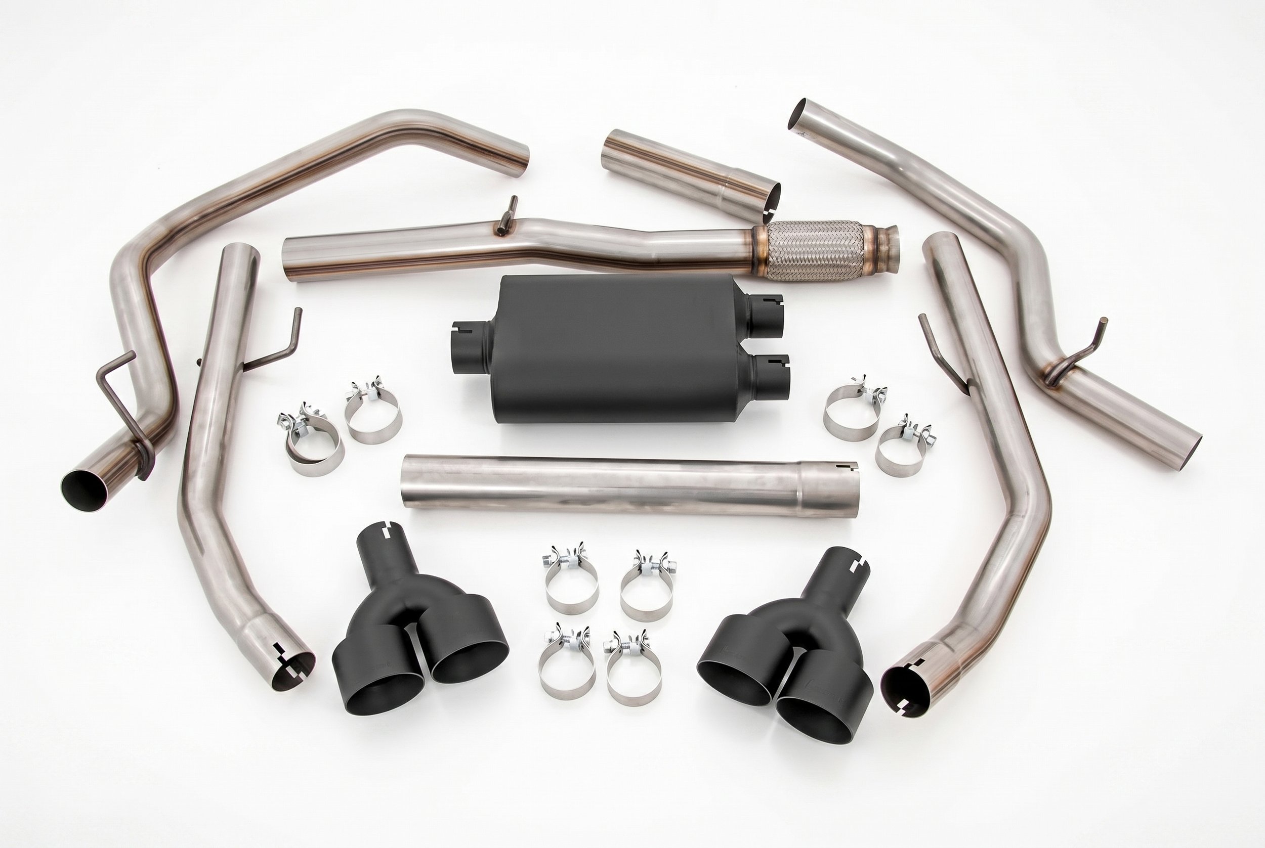 Complete aftermarket performance exhaust system with muffler, stainless pipes, clamps and quad exhaust tips ready for installation
