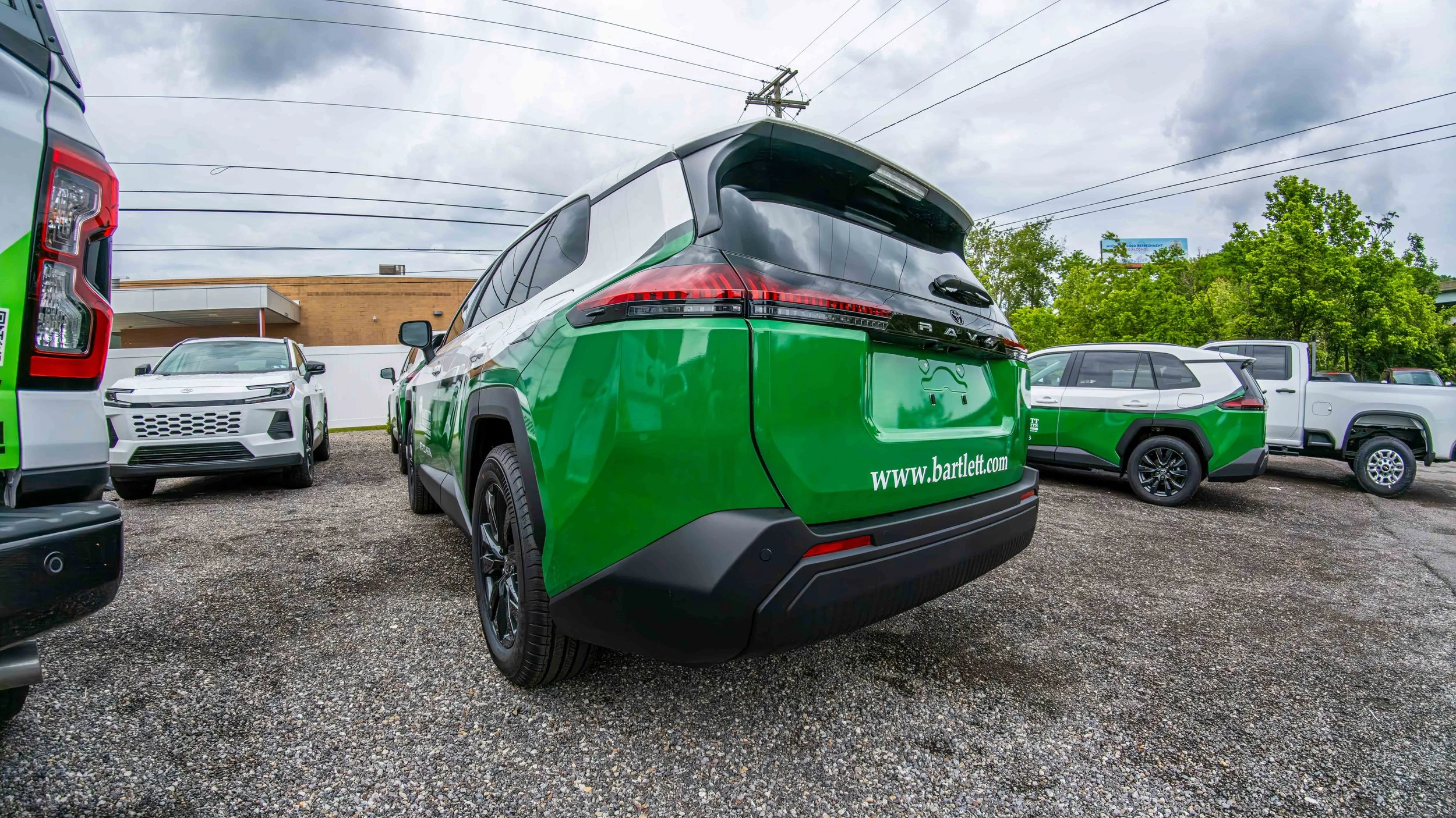 Toyota RAV4 fleet vehicles with custom green and white business graphics and commercial vehicle decals installed by Xtreme near Pittsburgh PA