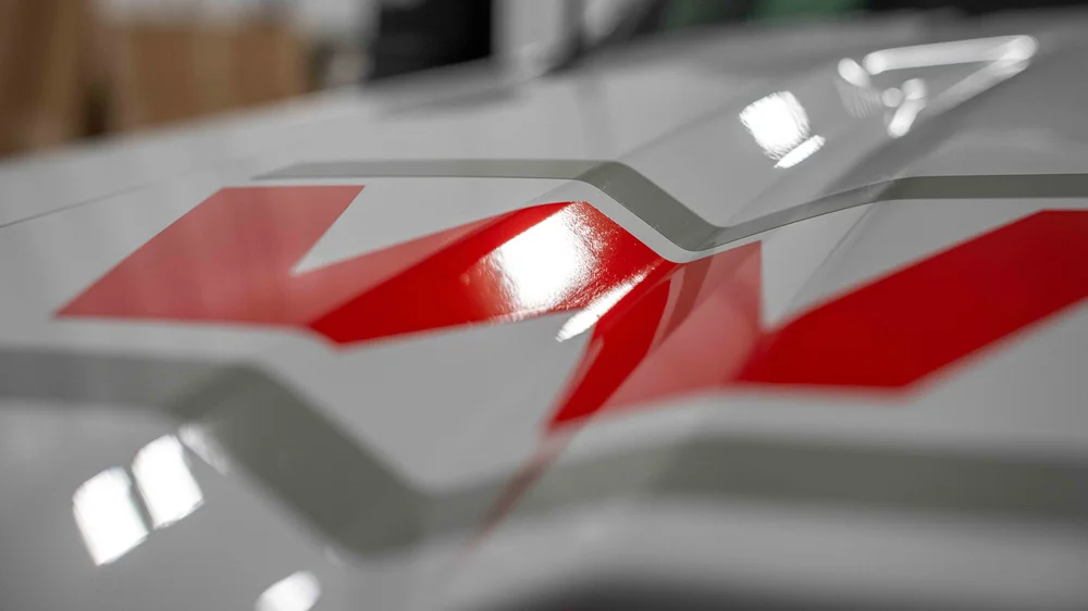 Close-up of custom red and gray vinyl truck graphics installed on a commercial work vehicle by Xtreme Car and Truck Accessories in Bridgeville, PA