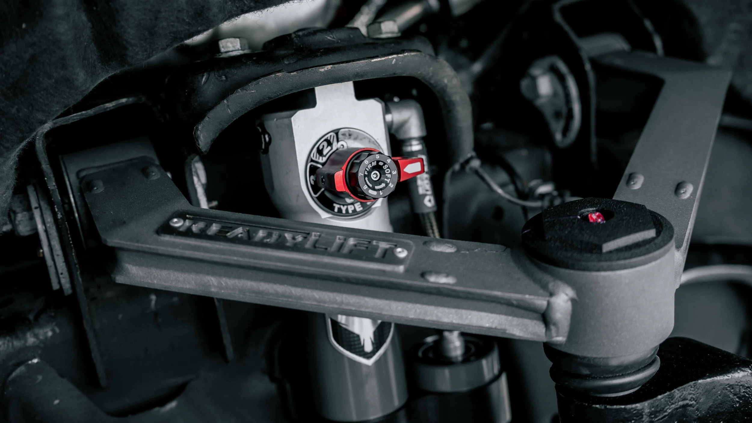 Close-up of ReadyLIFT upper control arm and Falcon 3.3 shock components installed on a GMC Sierra suspension lift in Bridgeville, PA.