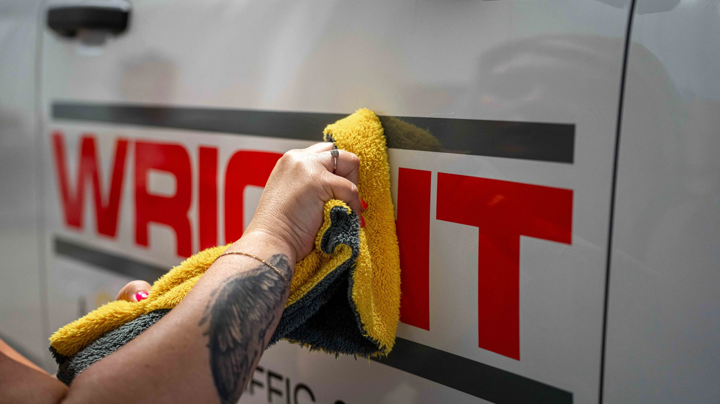 Final cleaning and finishing of W.D. Wright vinyl truck lettering for a commercial fleet vehicle at Xtreme Car and Truck Accessories
