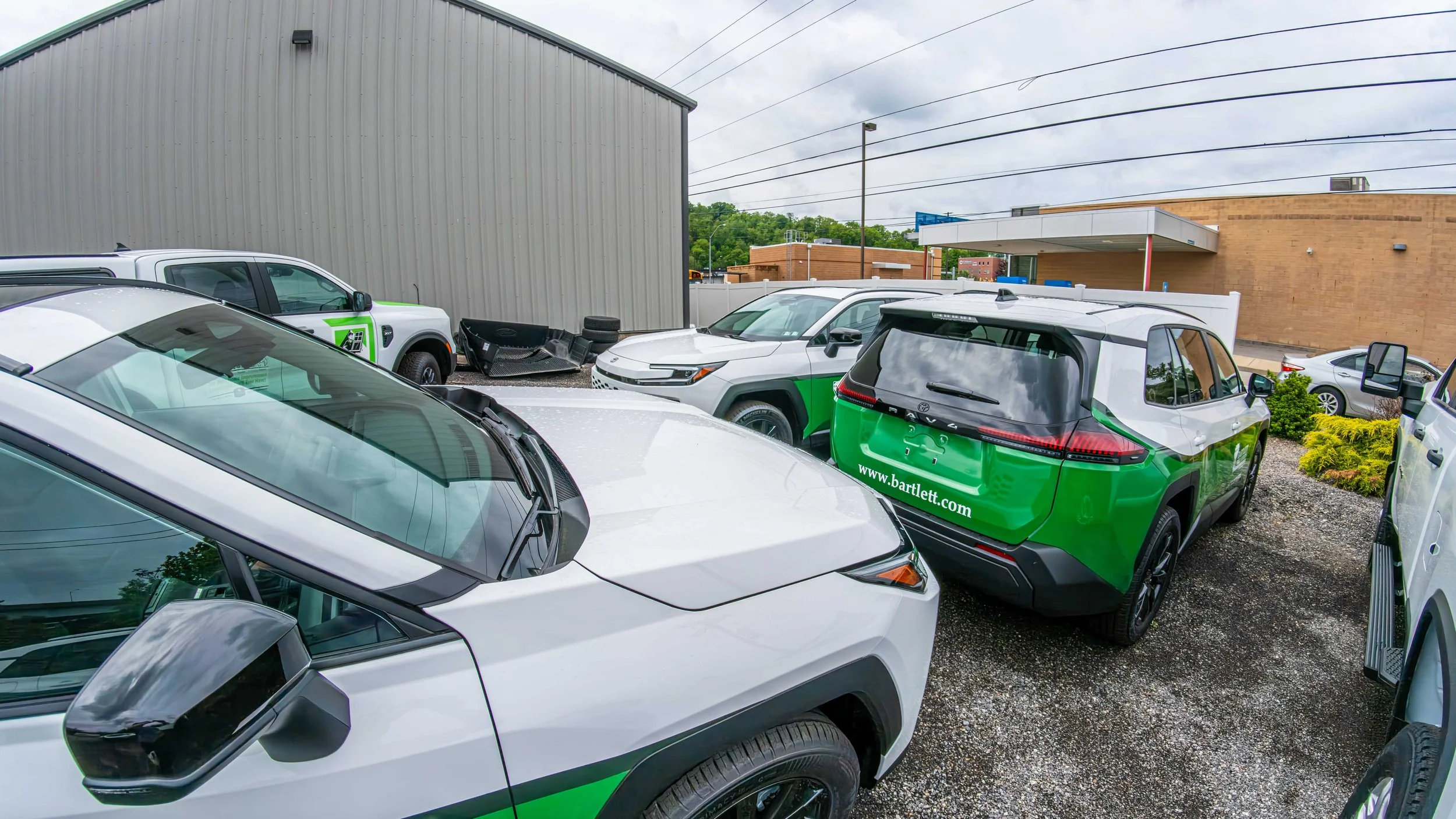 Fleet of Toyota RAV4 vehicles with matching company logos and vinyl graphics installed by Xtreme near the South Hills