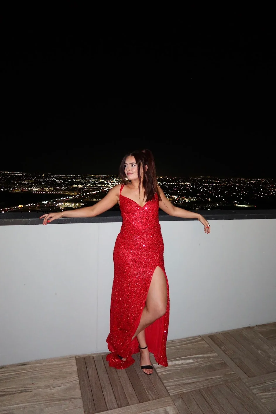 tanned woman standing against a wall