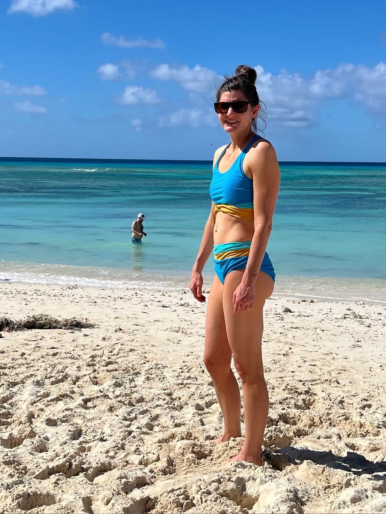 tanned woman standing on a beach