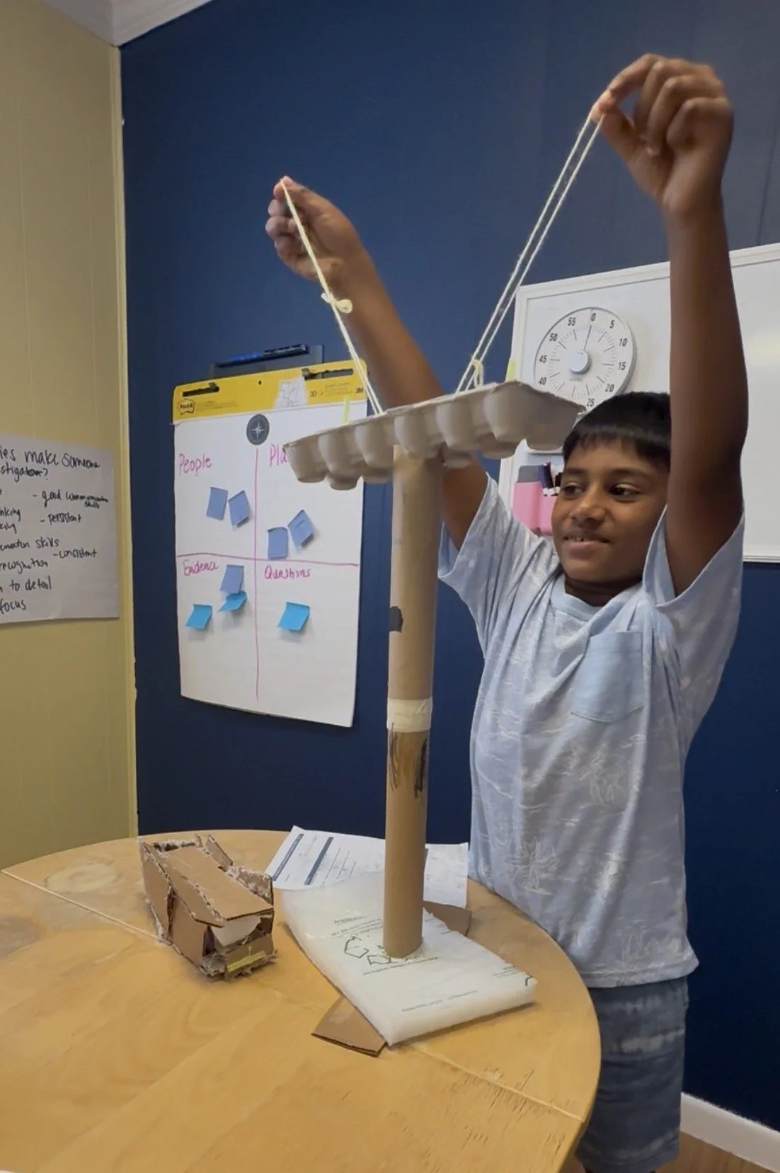 Student holding up a carnival ride build