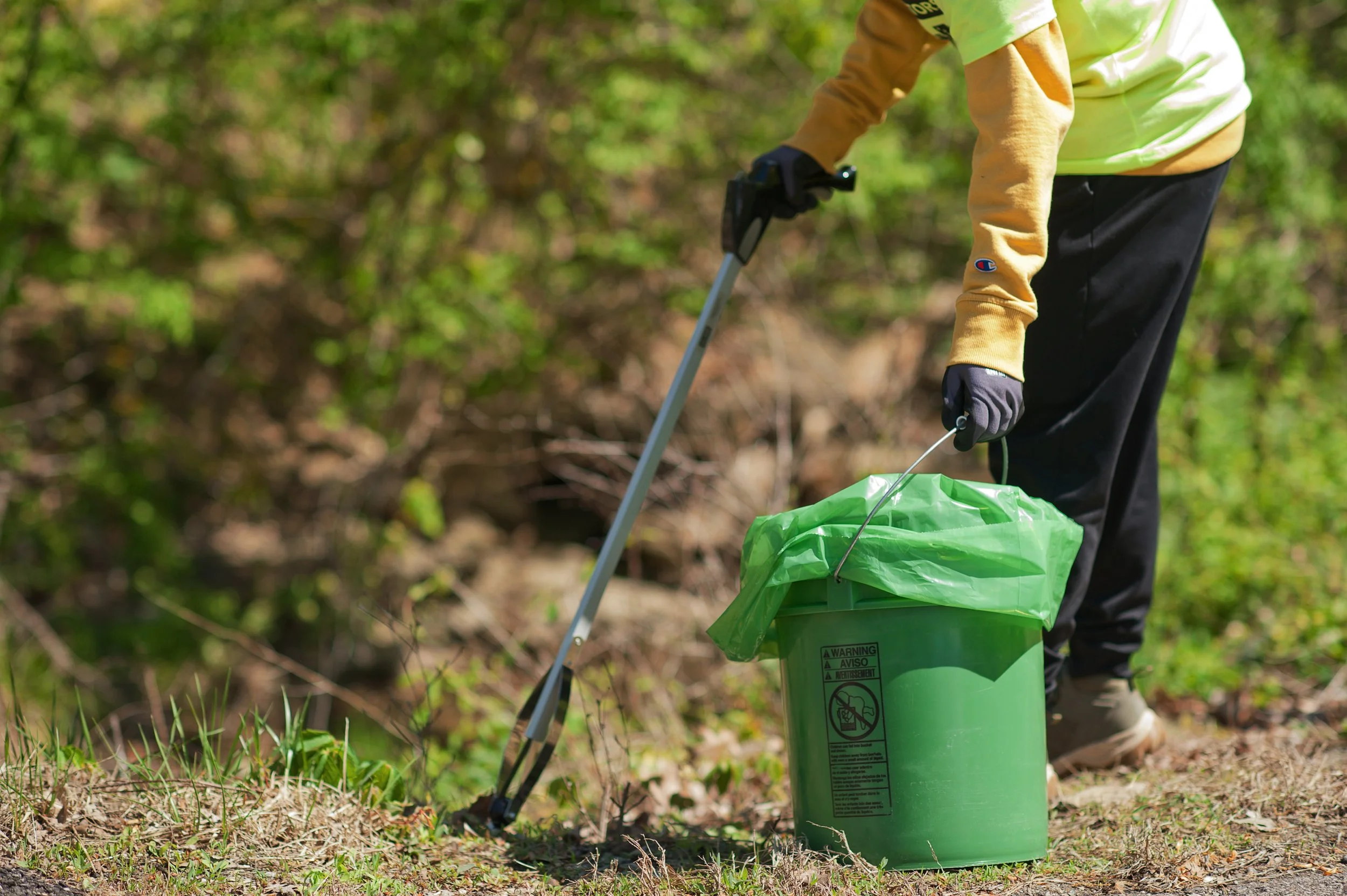 Volunteer collecting litter in a park