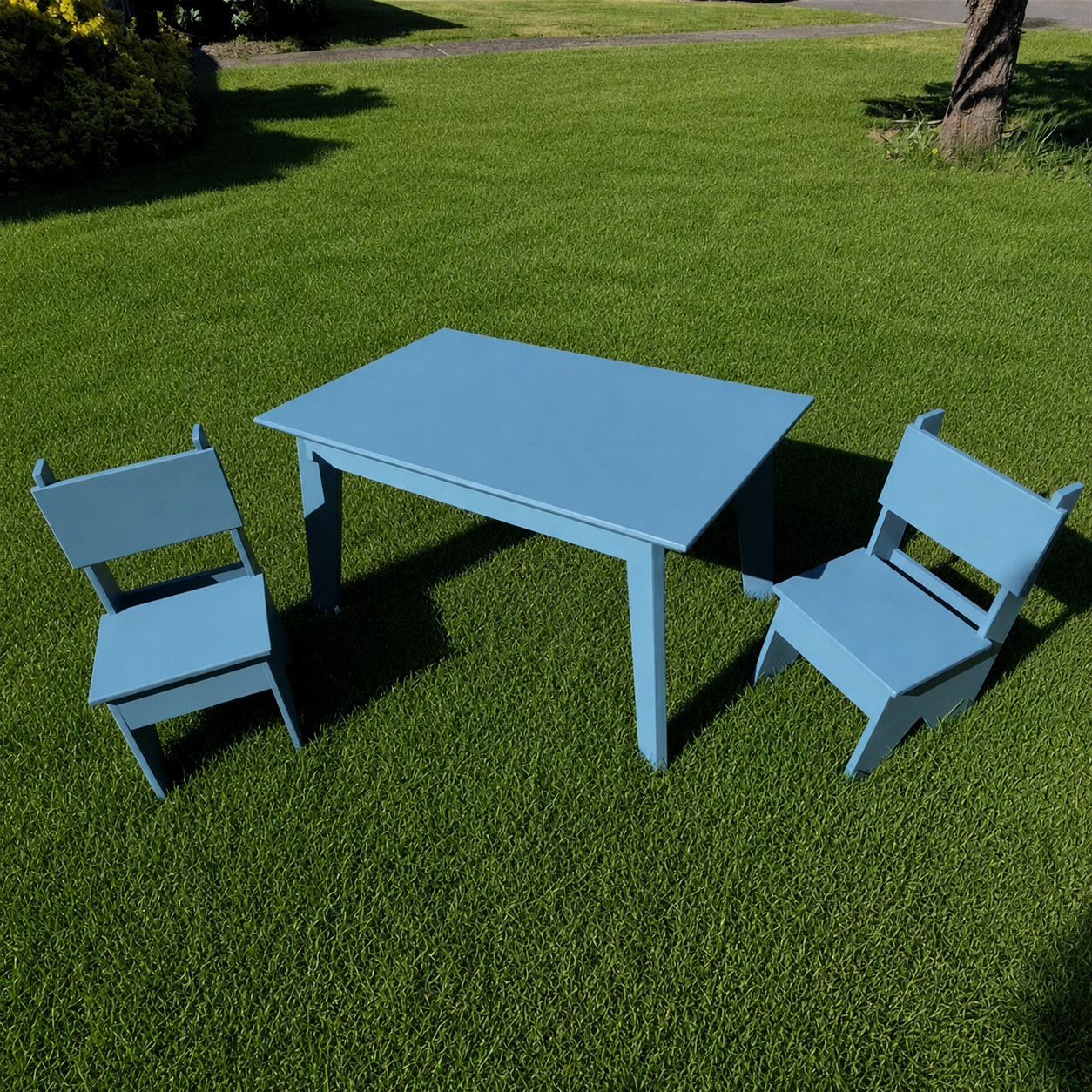 Blue Table child-sized table and chairs prototype built by Plane4 Grain on a sunny lawn