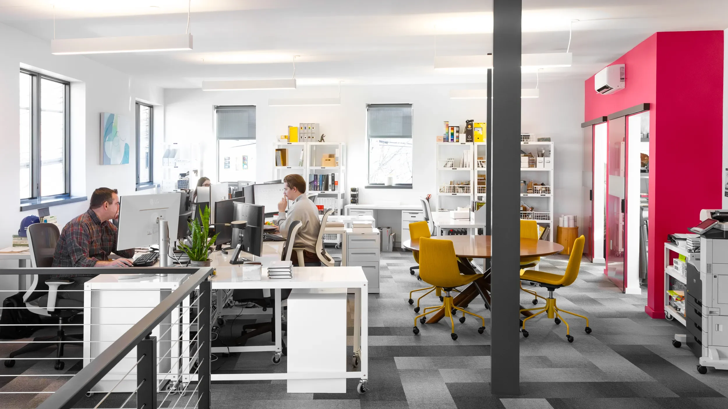 Open Winter Holben studio with desks, chairs, and people at work