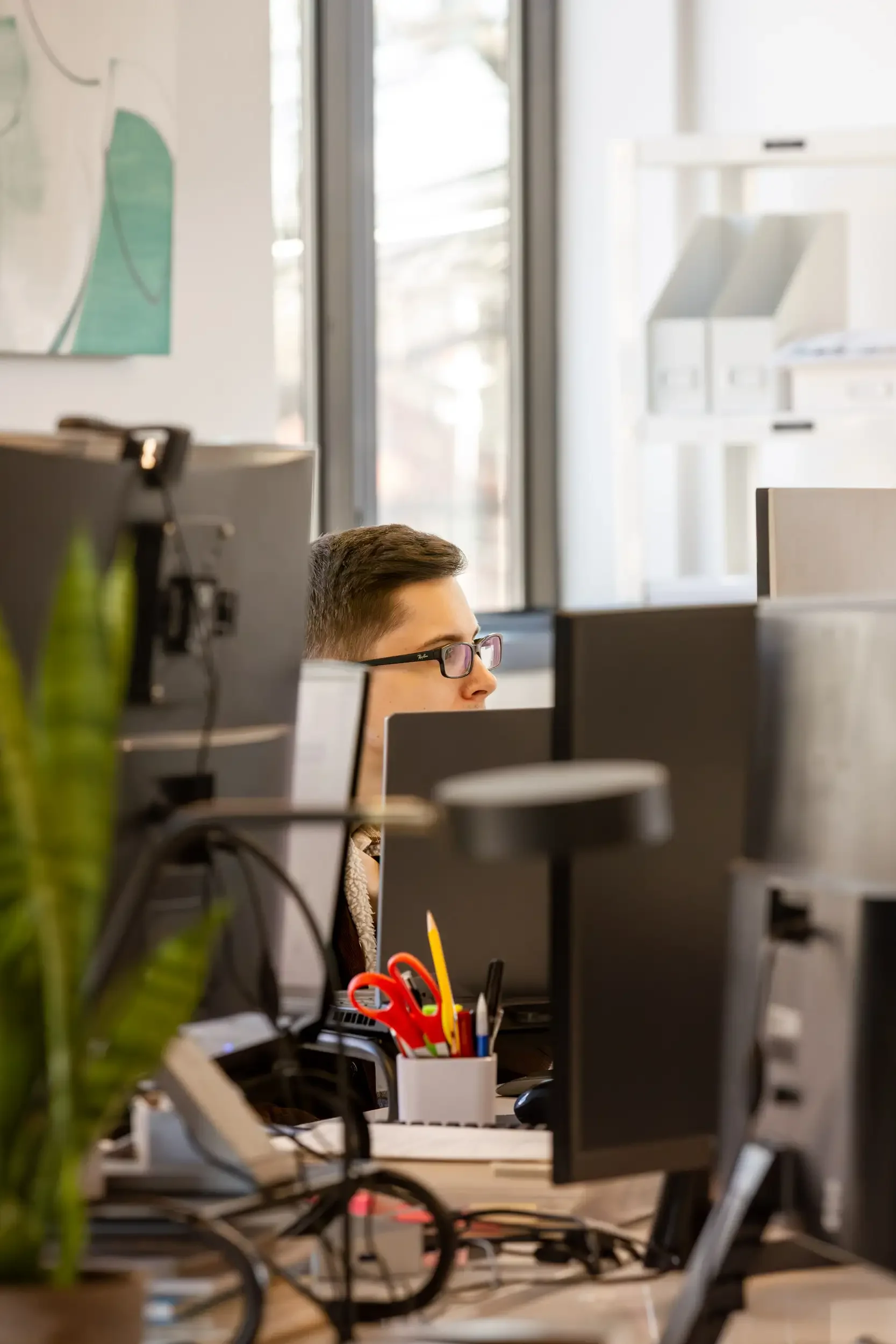 A team member working at a computer in the Winter Holben studio