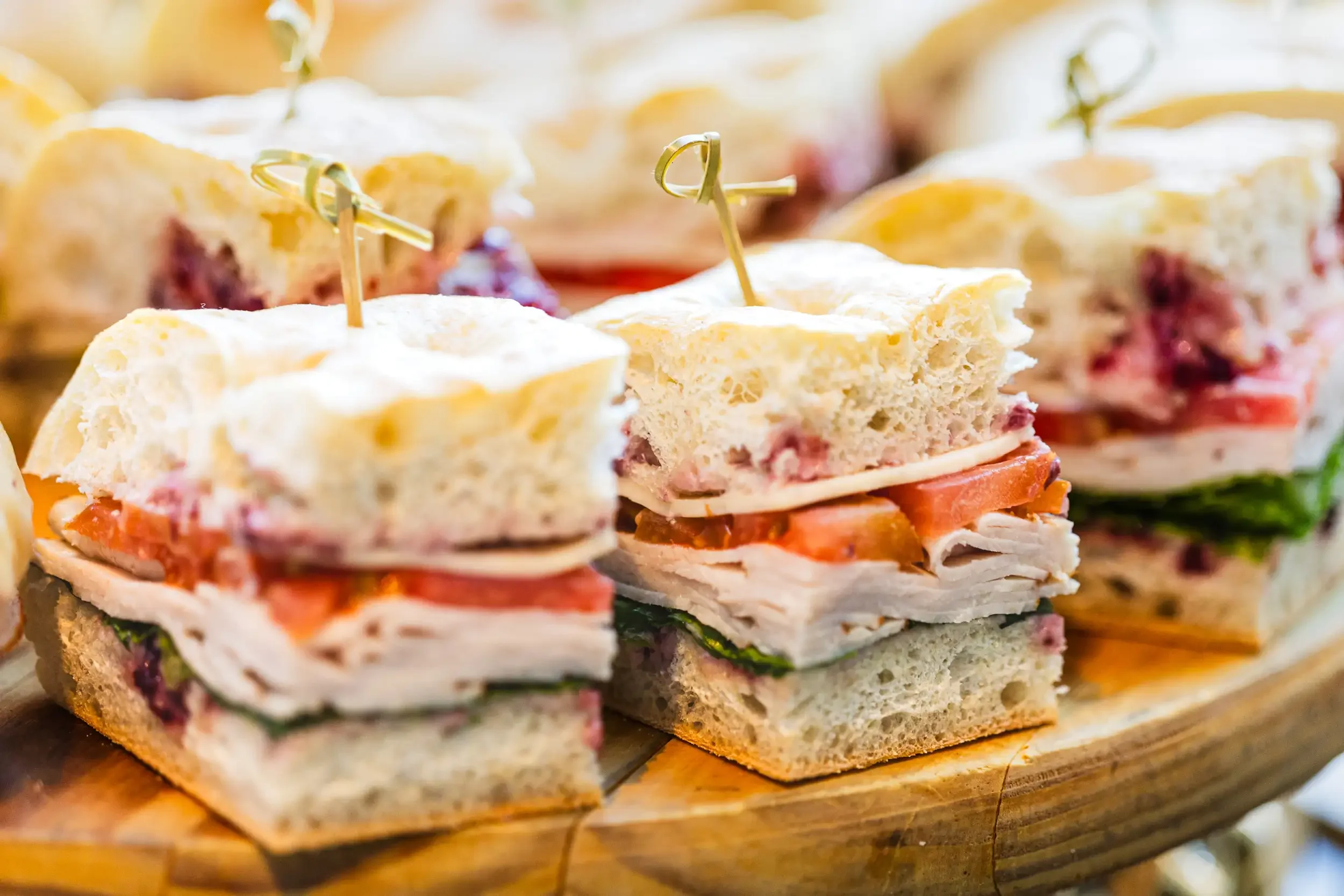 Layered sandwiches arranged on a serving platter