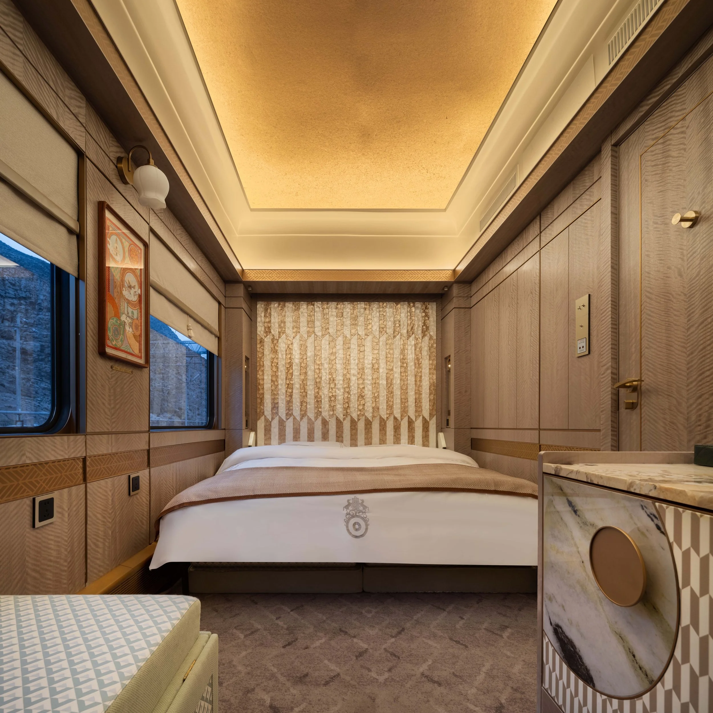 Silk Road Express Deluxe Suite (Family) with the double bed made up beneath a pearl-toned headboard panel