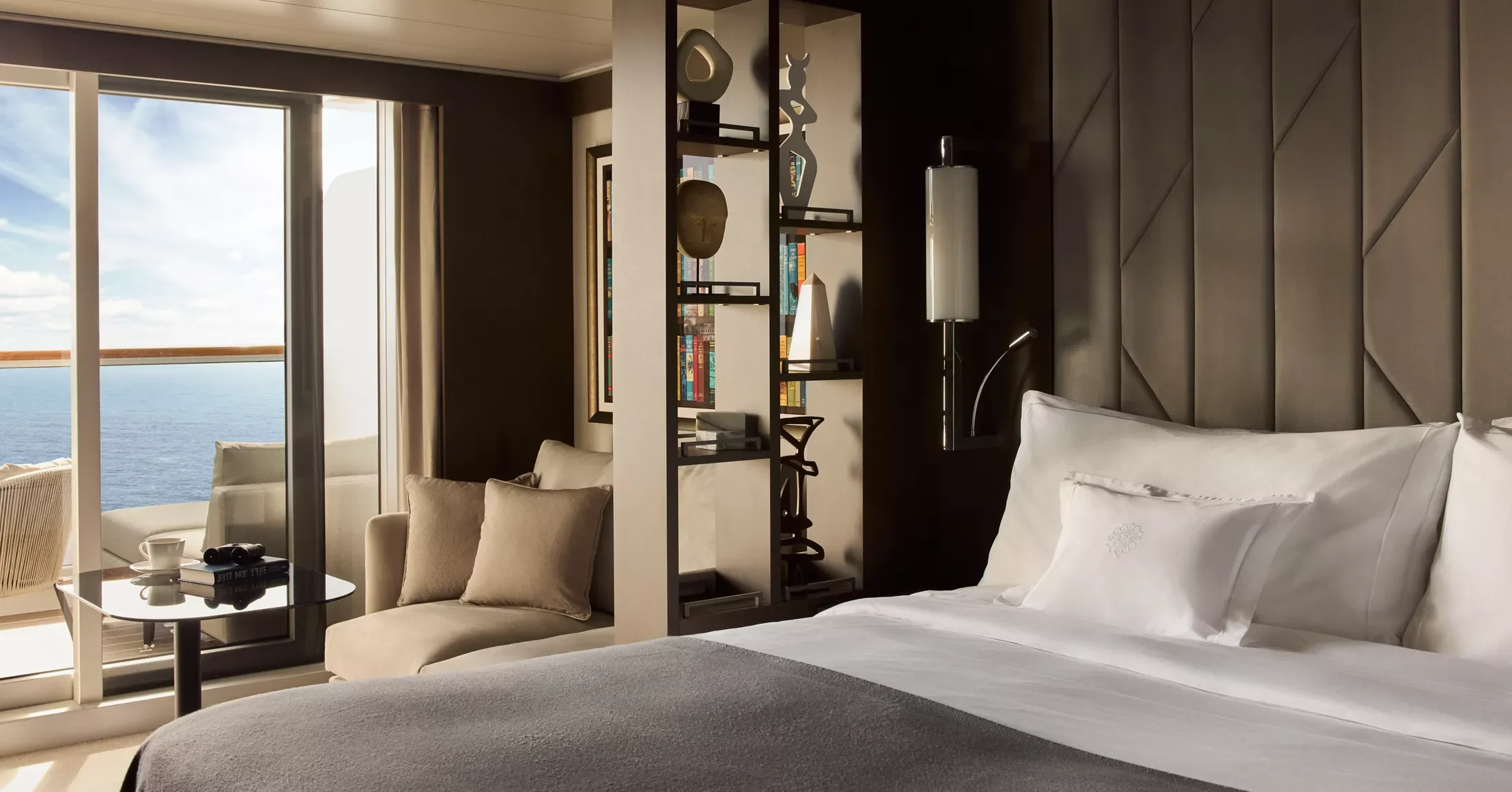 Explora Journeys Ocean Terrace Suite bedroom with sofa nook and sea-view terrace