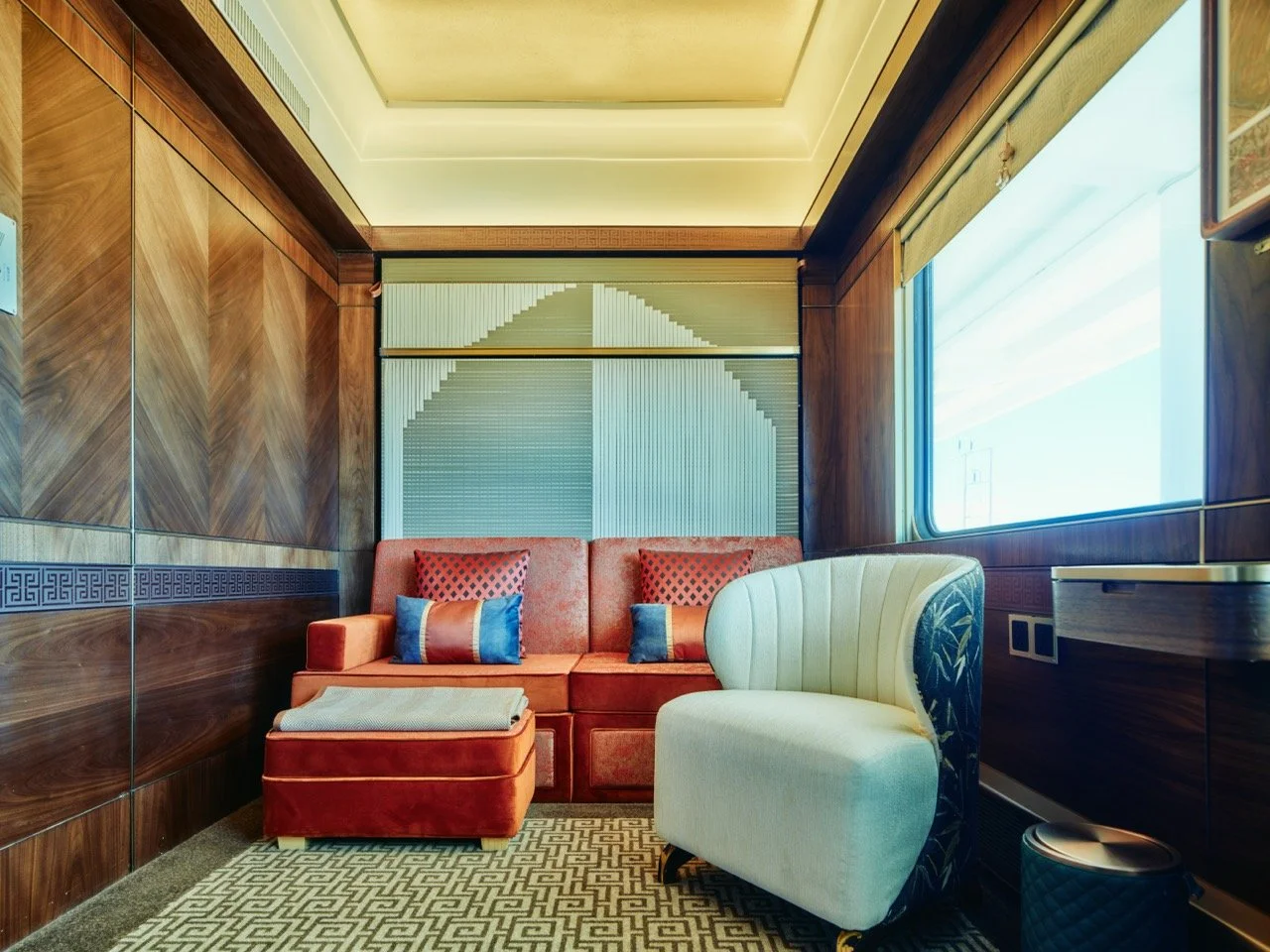 King Deluxe Suite on the Silk Road Express in day-time mode with sofa and armchair