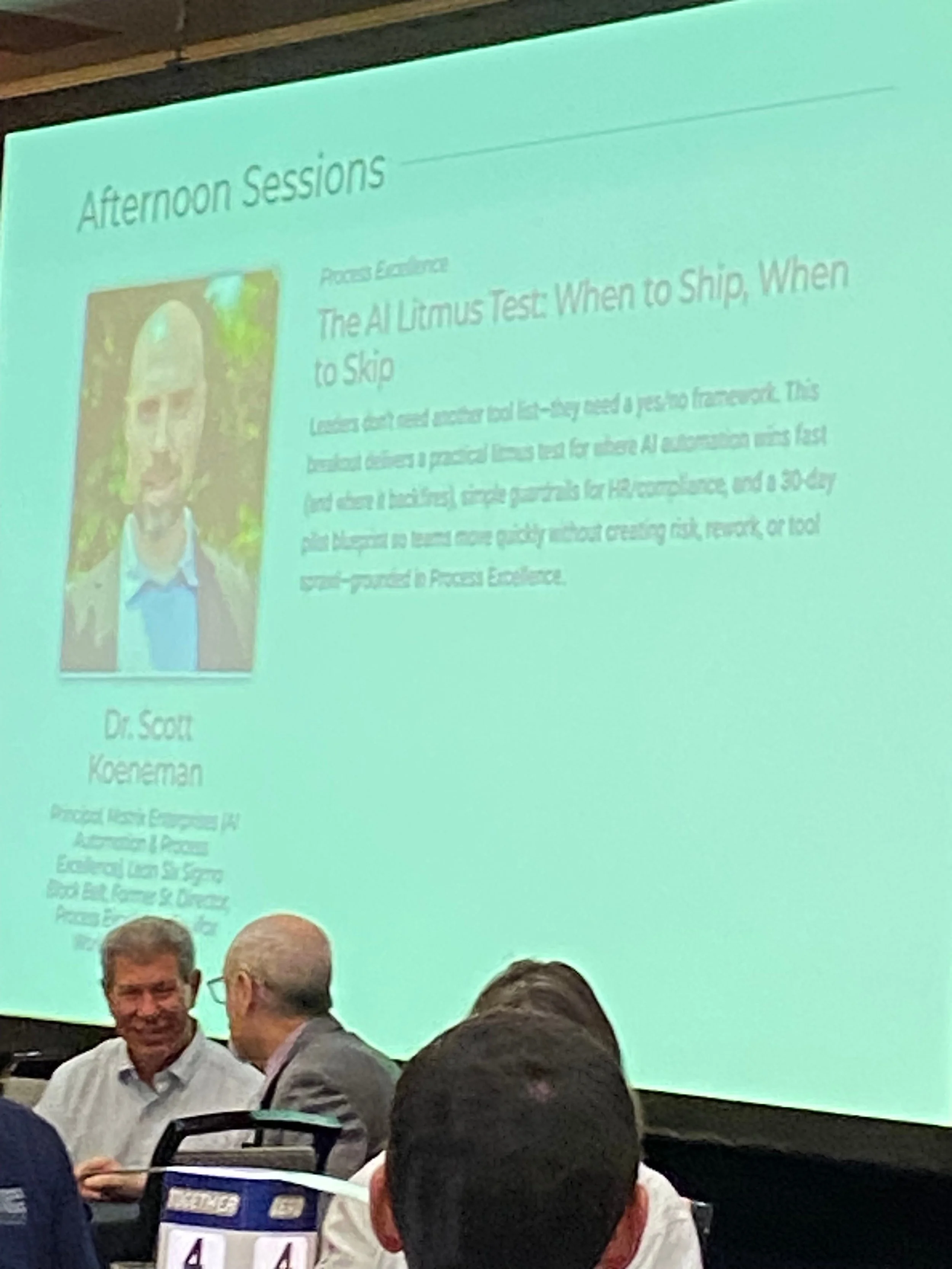 Conference screen showing Dr. Scott Koeneman breakout session profile